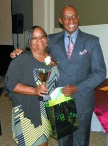Estelle Mangum, 2017-2018 Beginning Teacher of the Year, poses with Superintendent Anthony Jackson after accepting her award.